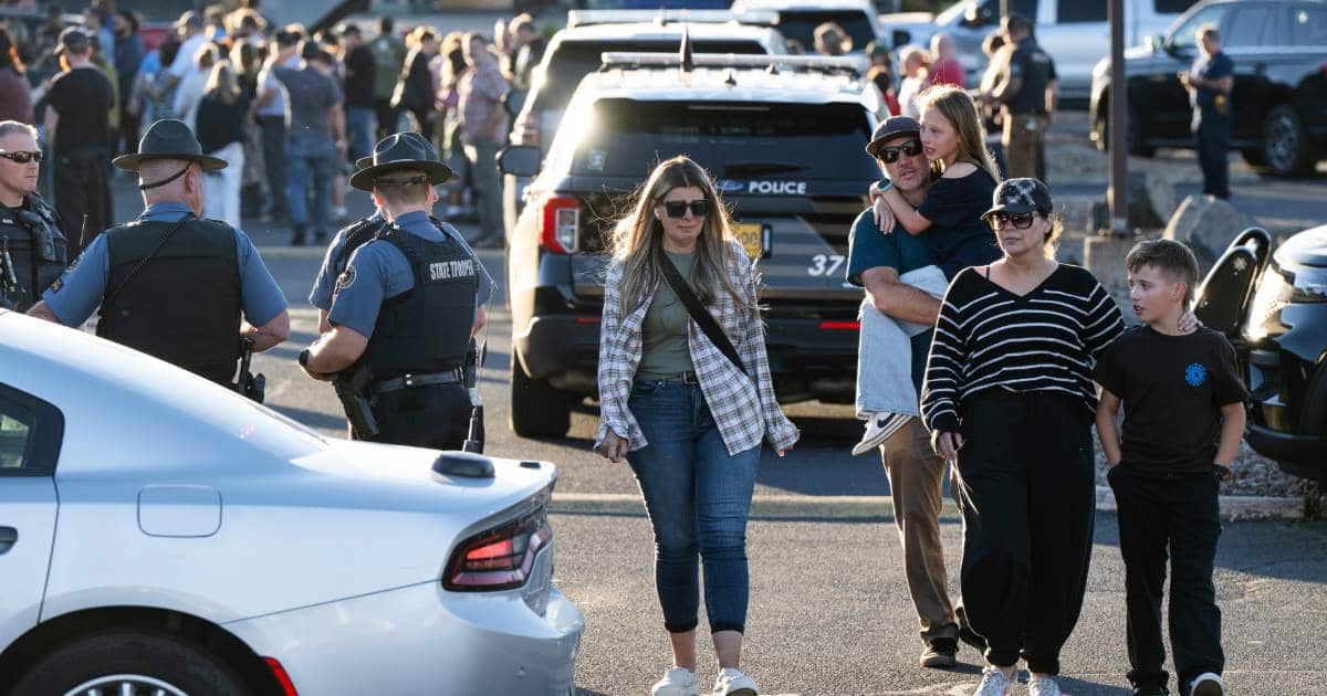 People leave a family meeting area following a shooting at Silver Rail Elementary School, Thursday, Oct. 15, 2026 (AP Photo/Joe Kline)