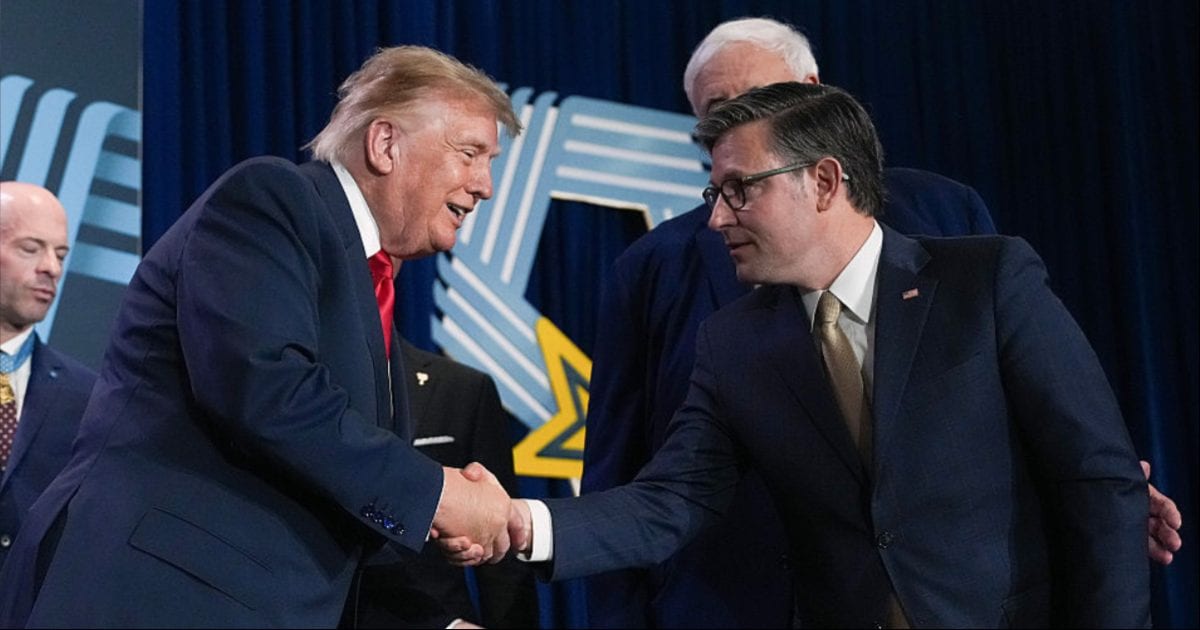 President Donald Trump (L) shakes hands with Speaker of the House Mike Johnson (R-LA) during an event at the National Medal of Honor Museum (Andrew Harnik/Getty Images)
