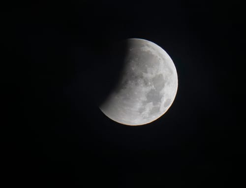 The beginning of a partial lunar eclipse is seen from Munich, Germany, Friday, Aug. 28, 2026. (Peter Kneffel/dpa via AP)