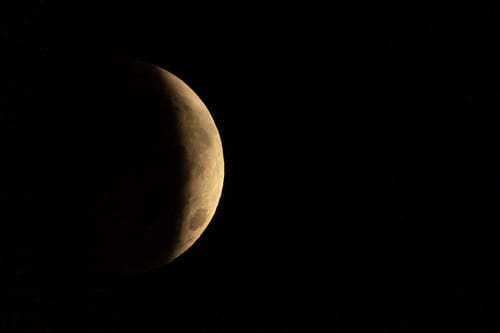 A partial lunar eclipse is seen across Pegwell Bay on August 28, 2026 in Ramsgate, England. The event saw the Moon obscured by Earth’s shadow, with around 93% of its visible diameter covered at the eclipse’s peak. (Photo by Brook Mitchell/Getty Images)