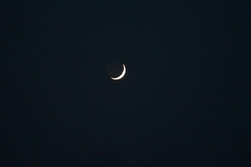 The image captures a bright crescent of the Moon in its waxing phase. This phase follows immediately after the New Moon phase.