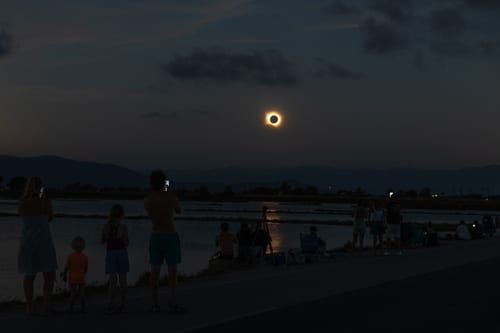 AMPOSTA, SPAIN - AUGUST 12: People gather to view a total solar eclipse on August 12, 2026 in the Ebro Delta near Amposta, Spain. It was the first time a total solar eclipse, when the sun is blocked by the moon's orbit, could be viewed from Spain since 1905. (Photo by James Breeden/Getty Images)