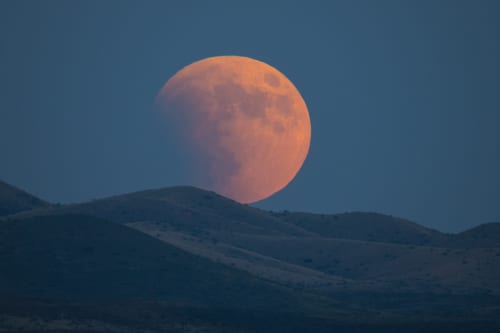 Super-blood moon rises over the Dragoon Mountains as viewed from Tombstone, Arizona