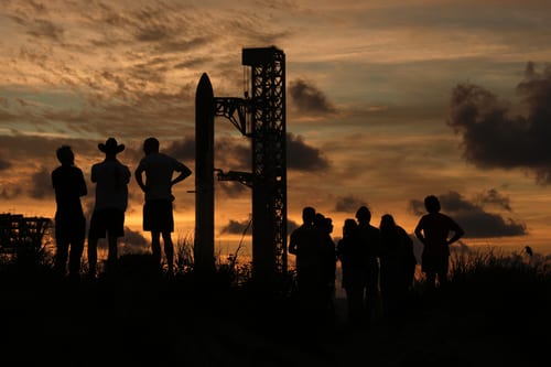People gather at sunset as Starship is prepared for Flight 14 from Starbase, Texas. (Image Source: AP Photo | Eric Gay)