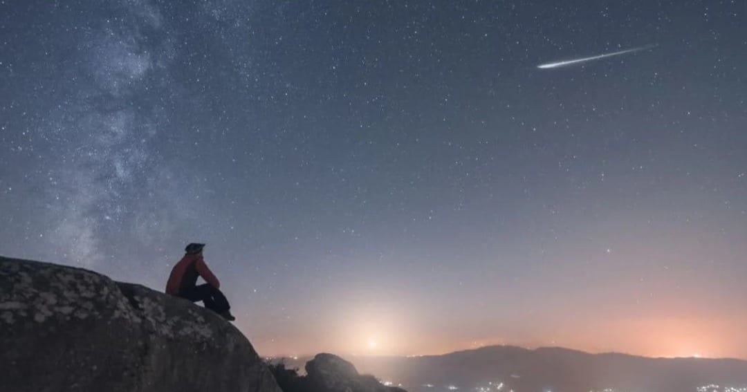 A man watching a shooting star, and the Milky Way. (Representative Cover Image Source: Getty | Carlos Fernandez)