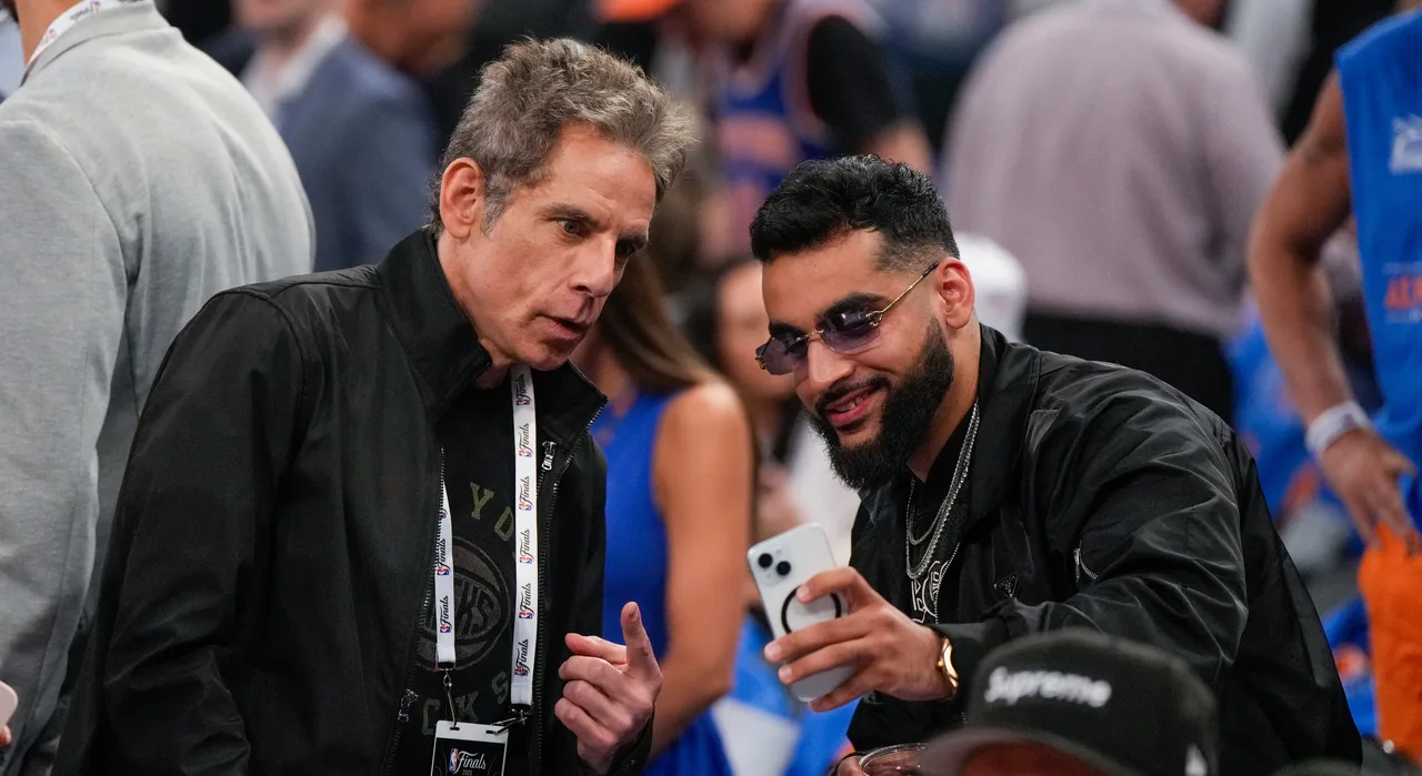 Ben Stiller pauses for a courtside selfie with a fan