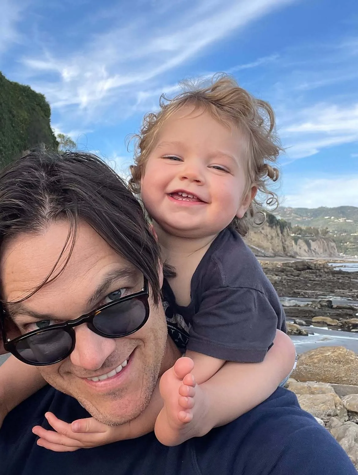 Christopher French lovingly carries Emerson on his shoulders