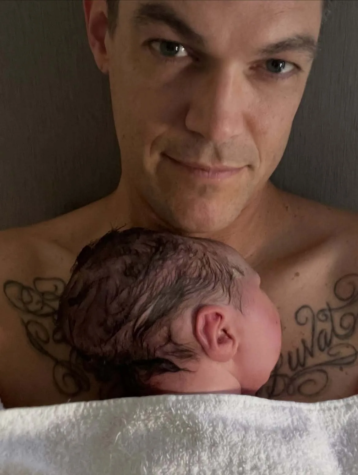 Christopher French holds newborn Emerson close
