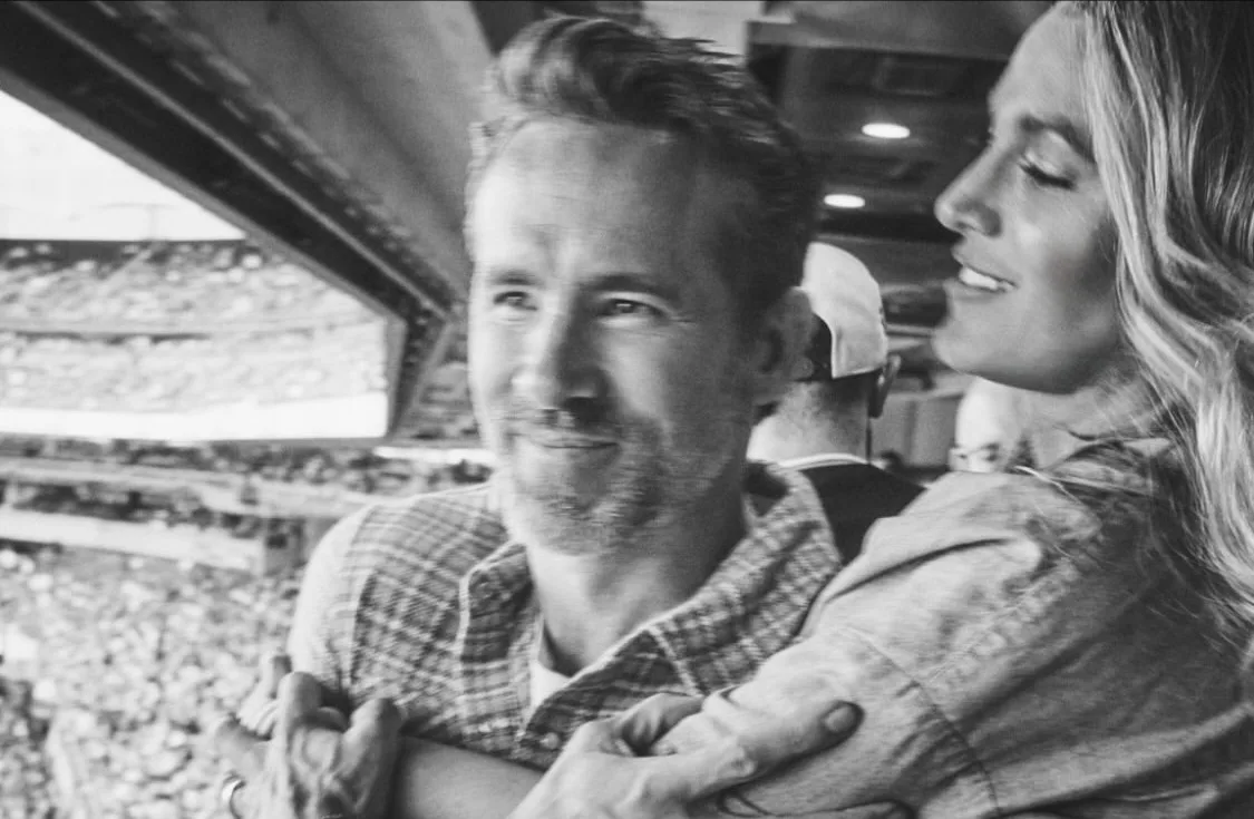 Blake Lively and Ryan Reynolds share a sweet moment during the match