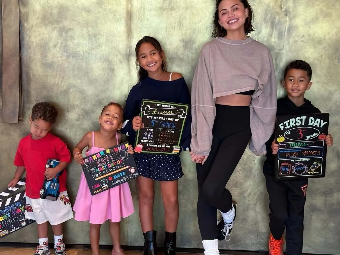 Chrissy Teigen happily poses with all her children