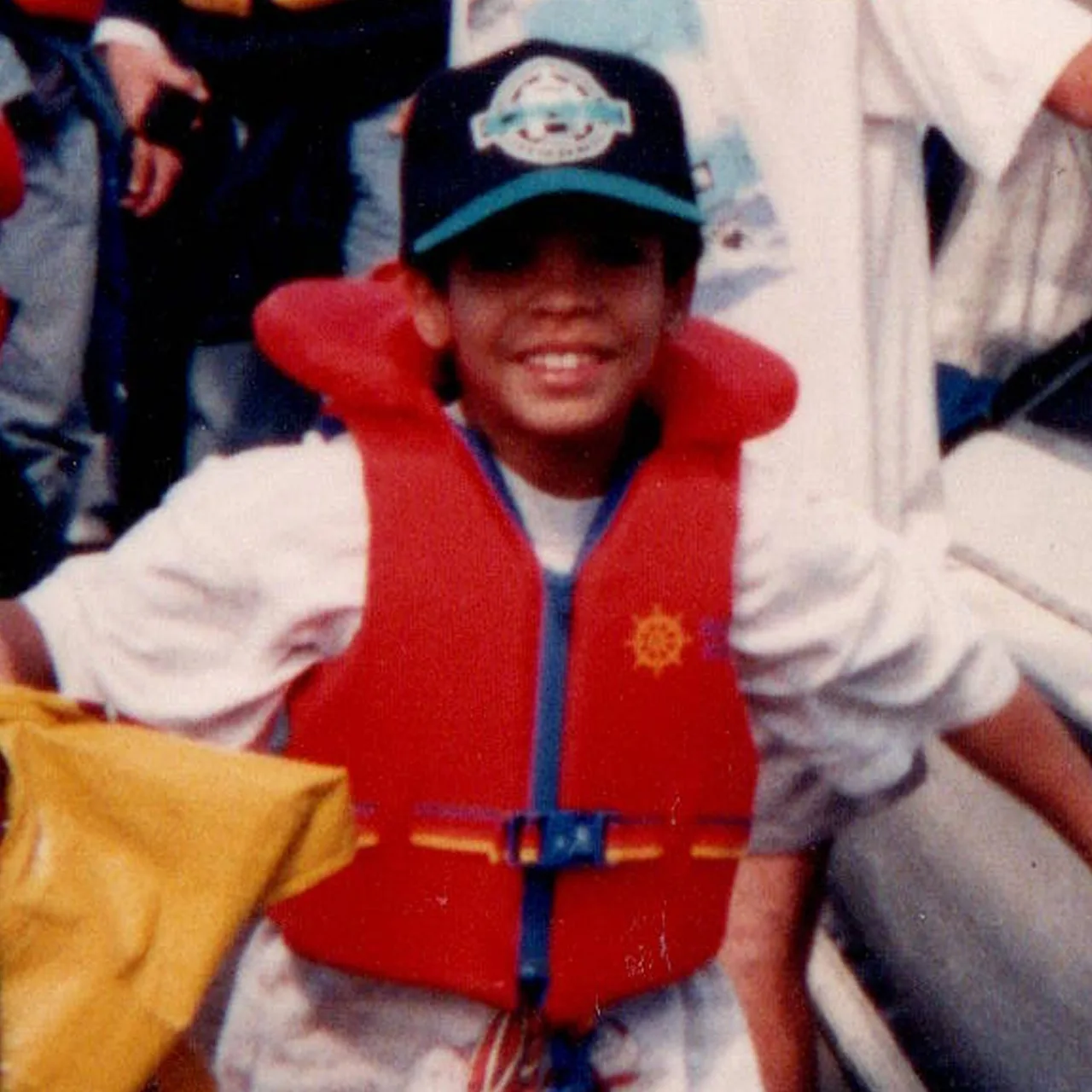 Little Drake poses wearing red life jacket