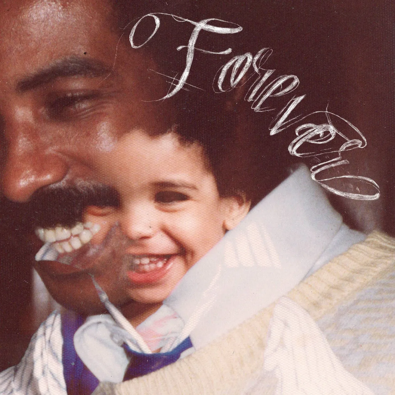 Drake smiles alongside his father in a childhood photo