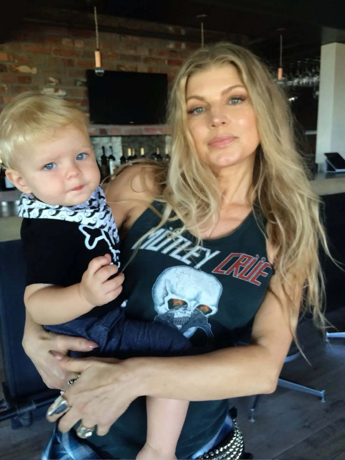 Fergie poses with baby Axl in her arms