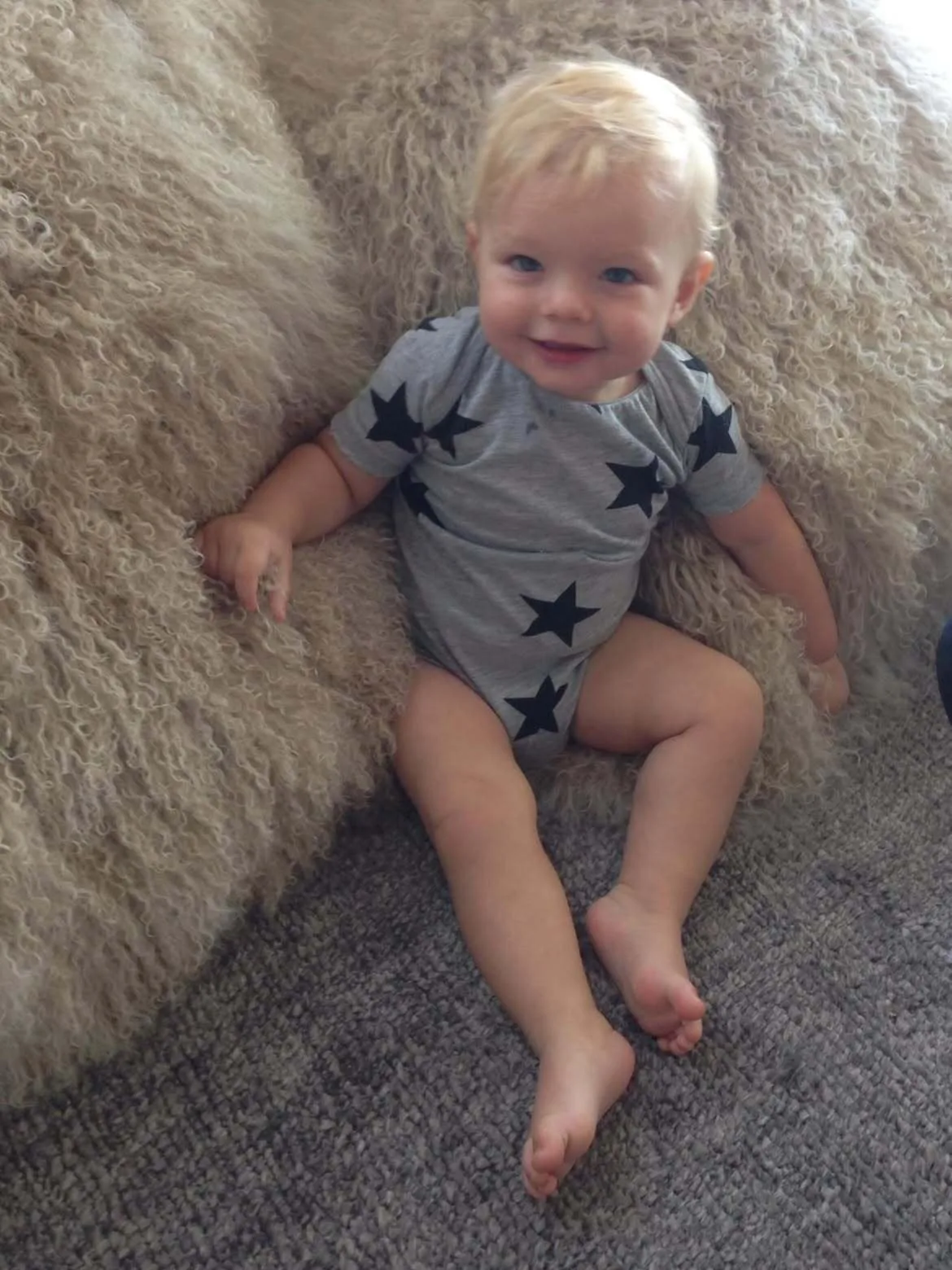 Baby Axl poses in a star-print onesie