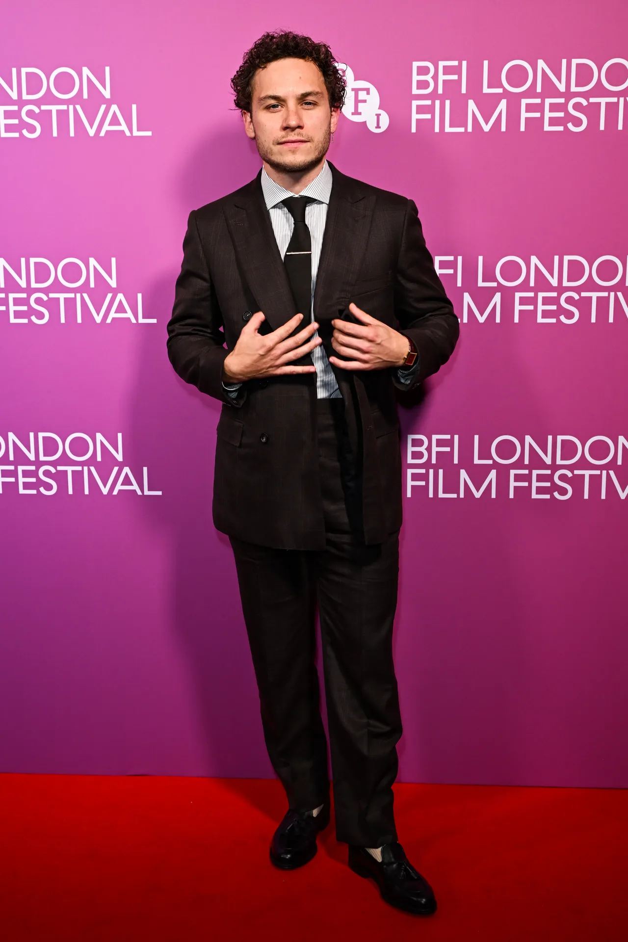 Finn Cole serves dapper look in black suit
