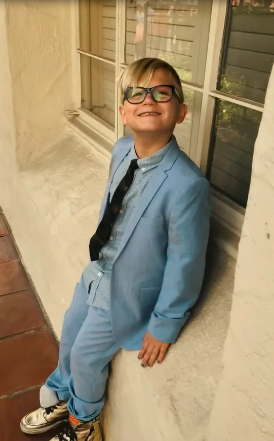 Little Zuma poses in style wearing formal attire