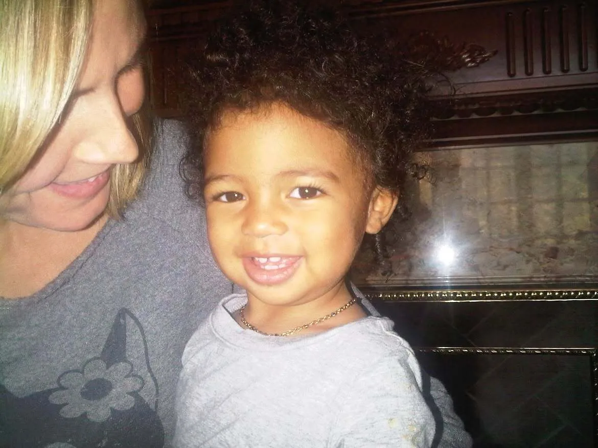 Young Lou Sulola Samuel adorably smiles at the camera