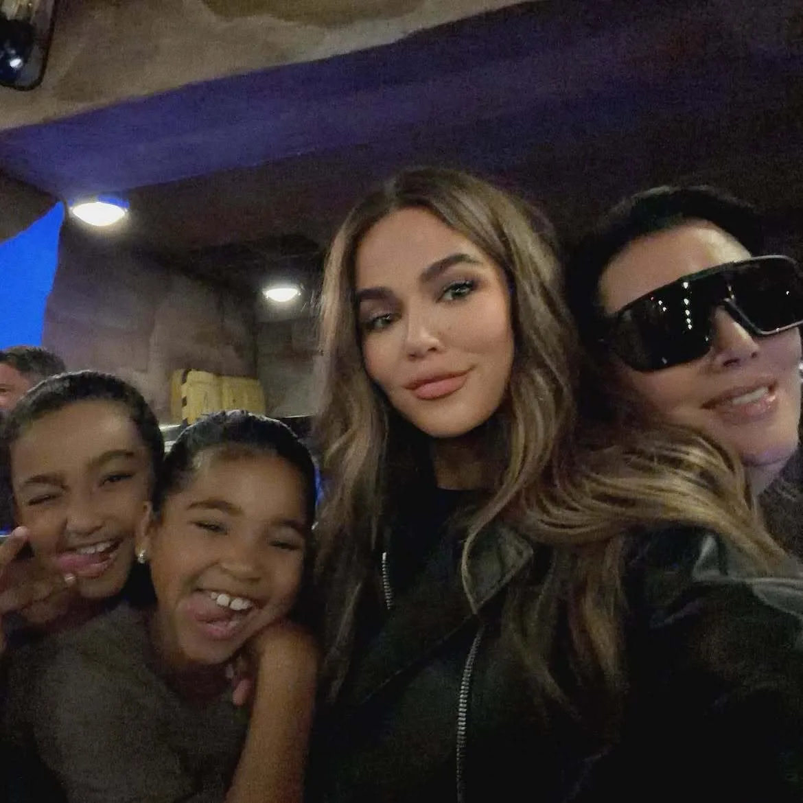 Khloe poses candidly alongside mom and children