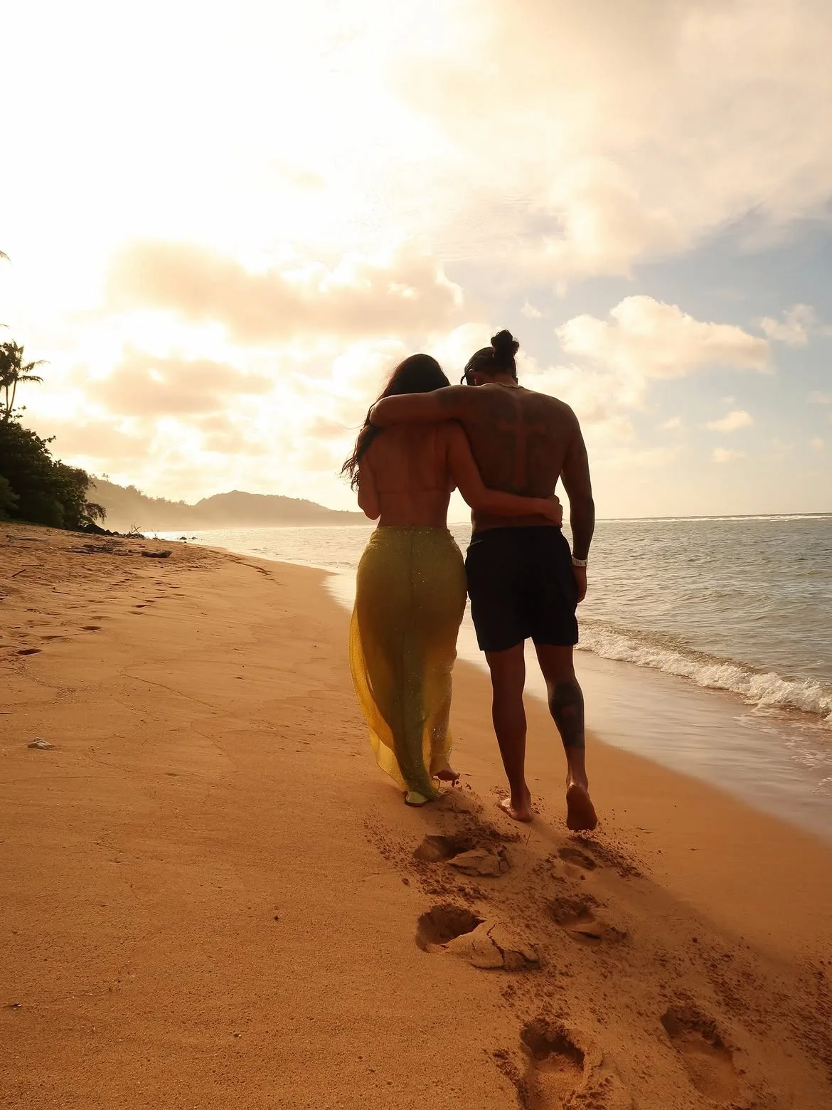 Kim Kardashian and Lewis Hamilton take a stroll along the beach