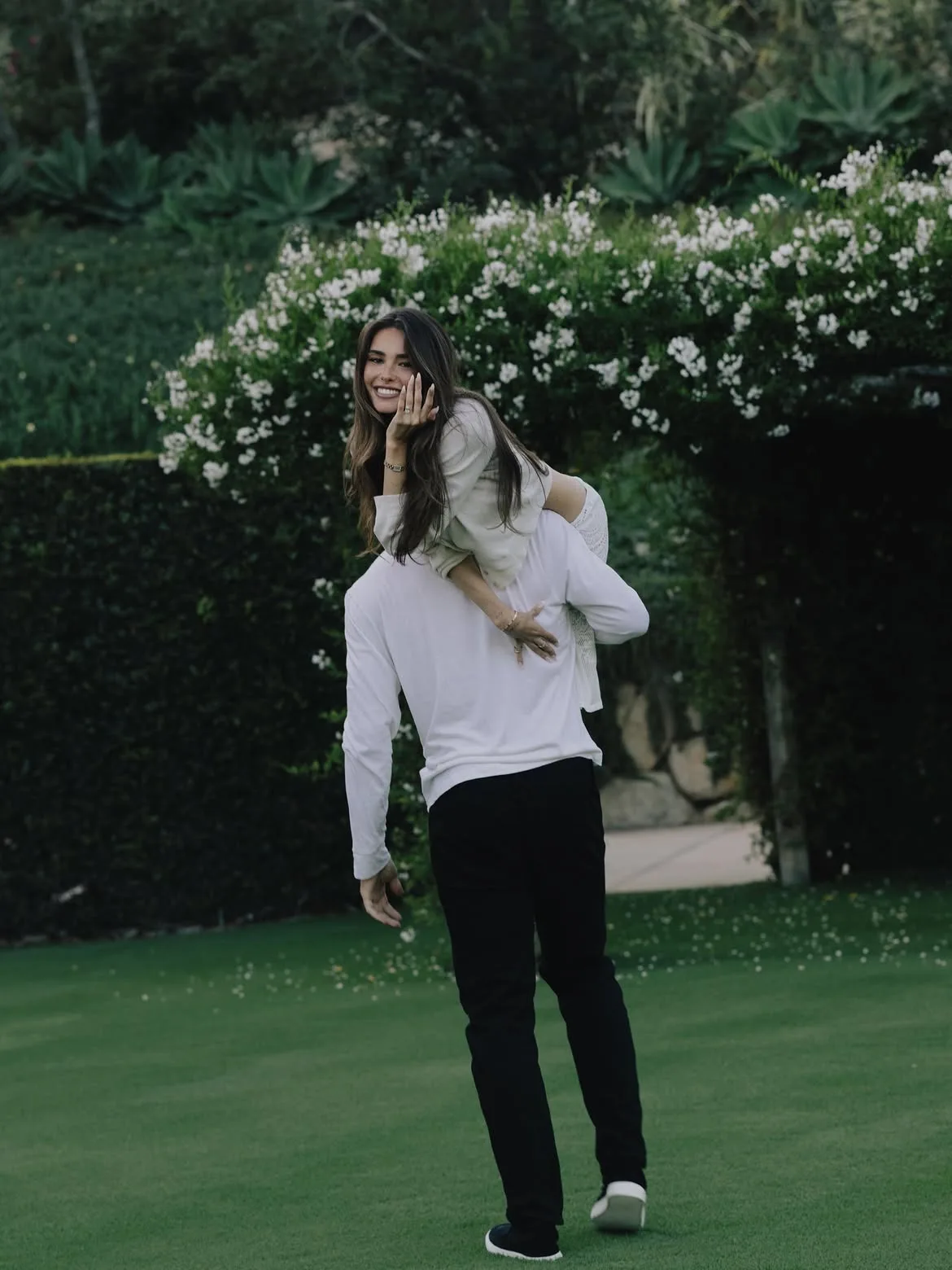 Justin Herbert carries Madison Beer as she shows off her sparkly bling