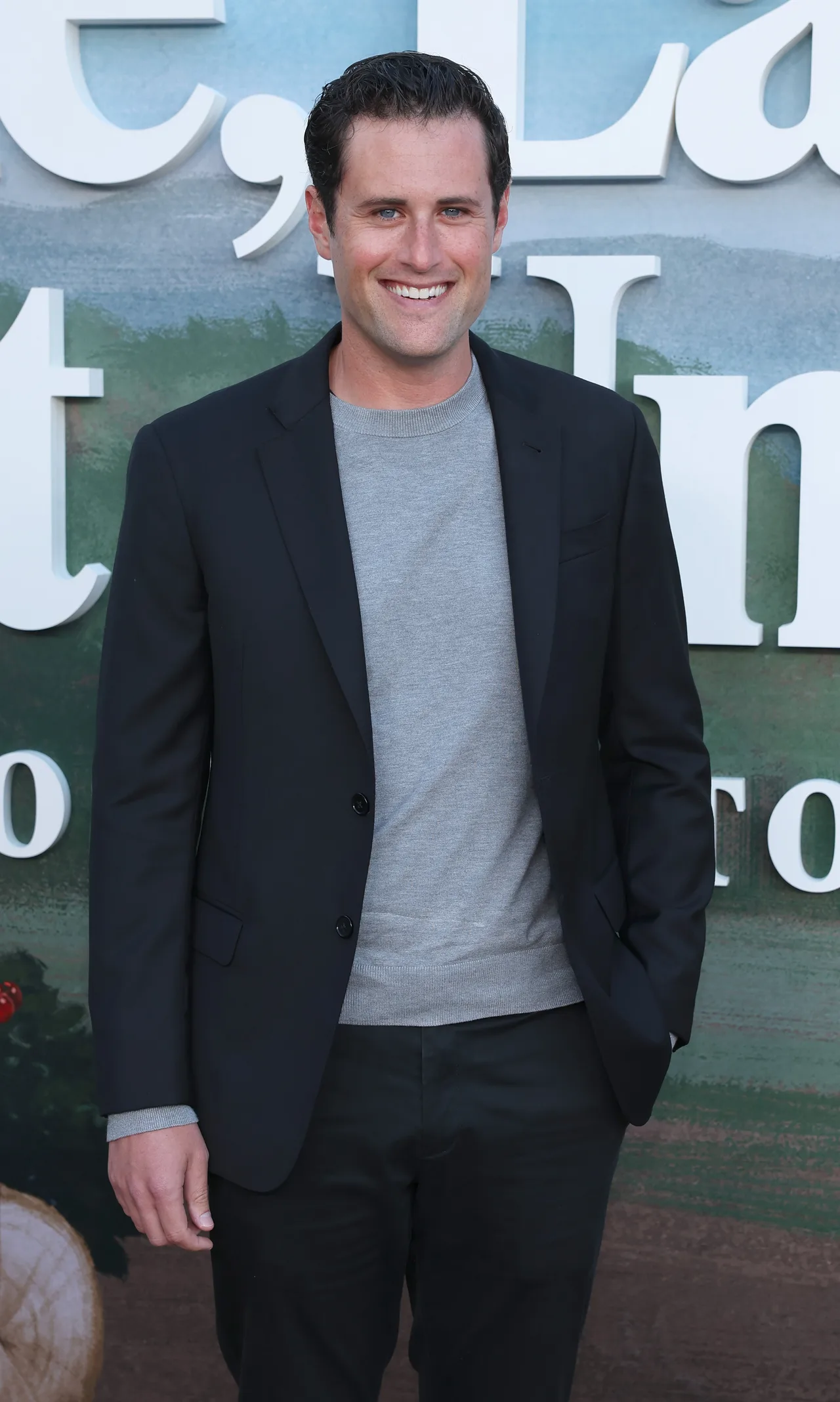 Jake Reiner keeps it sleek in tailored black ensemble