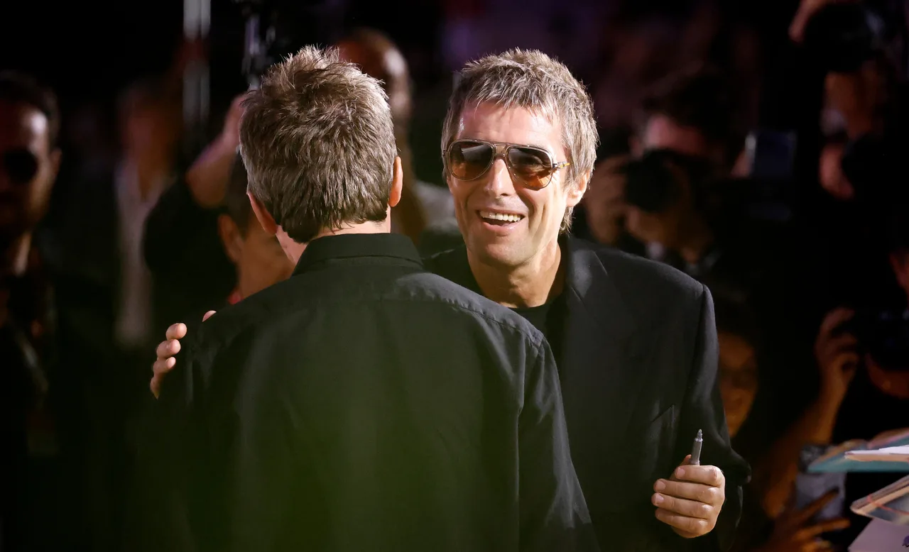 Gallagher brothers appears to share a hug during Venice red carpet