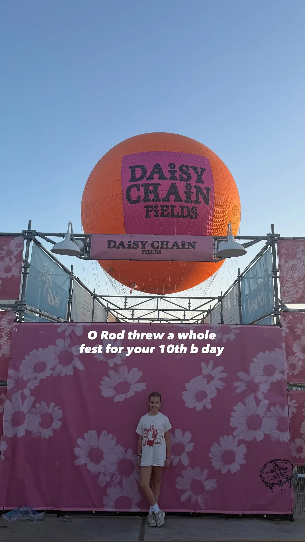 Olivia Wilde's daughter Daisy poses in front of Daisy Chain Fields' sign