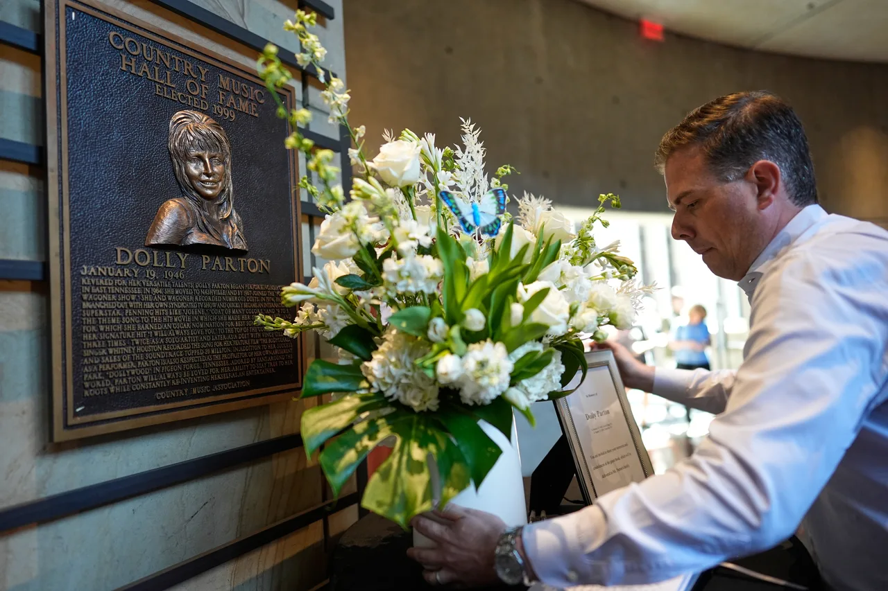 Flowers placed near Dolly Parton's Country Music Hall of Fame plaque
