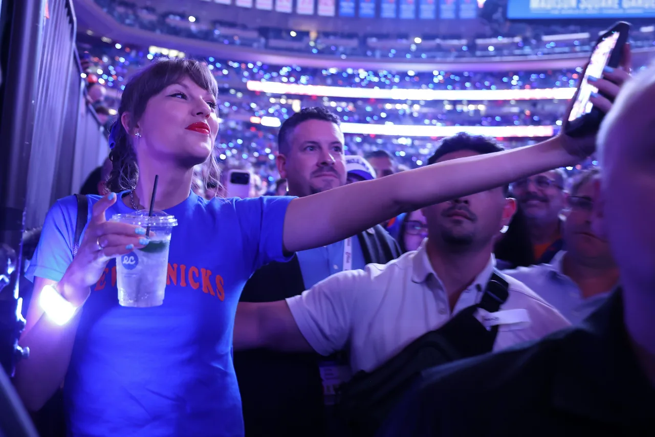 Taylor Swift pauses to take a selfie with a fan