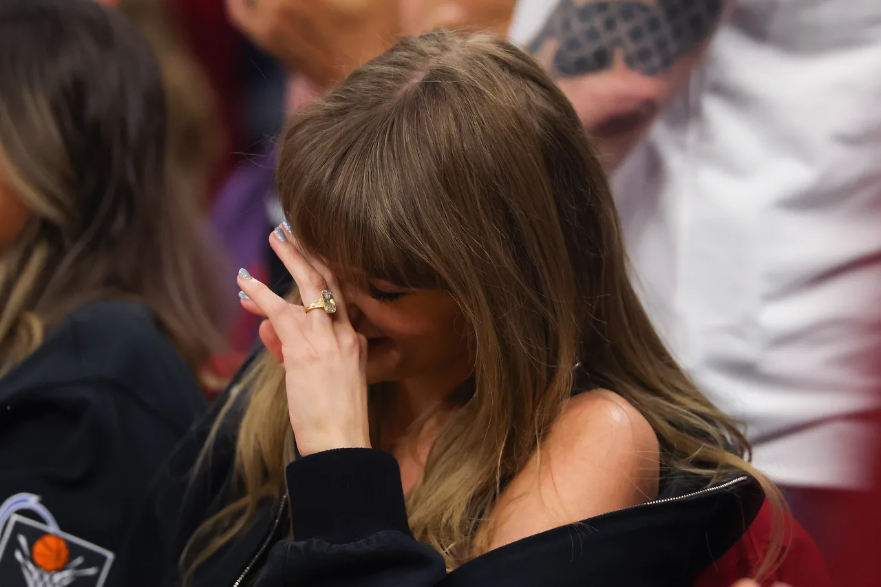 Taylor Swift covers her face in response to Travis Kelce's jumbotron clip