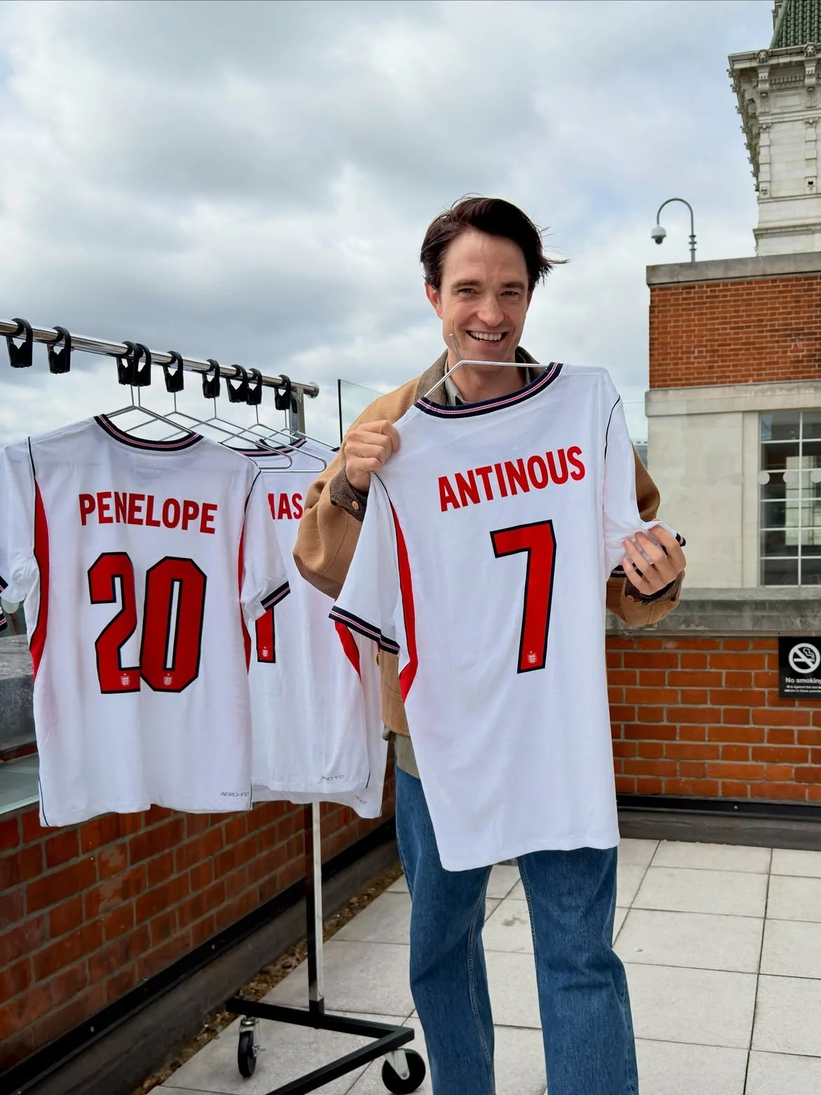 Robert Pattinson is all smiles with Antinous jersey