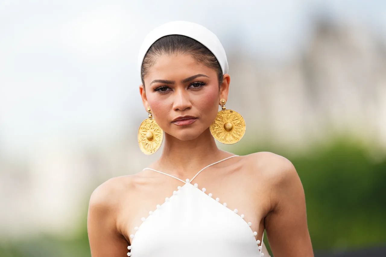 Zendaya completes her look with oversized gold medallion earrings