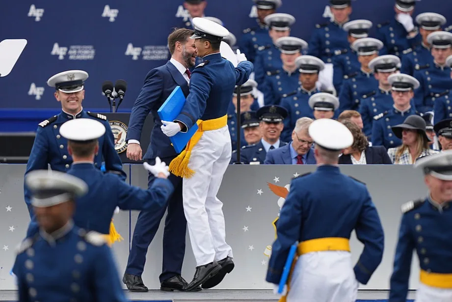 Vance playfully gives a chest bump to cadet at Air Force Academy