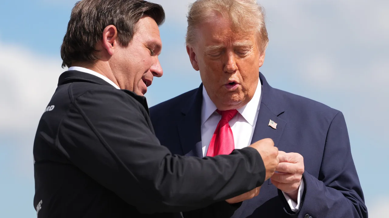 Ron DeSantis surprises Trump with cheeky gold coin as he arrives for Florida campaign rally