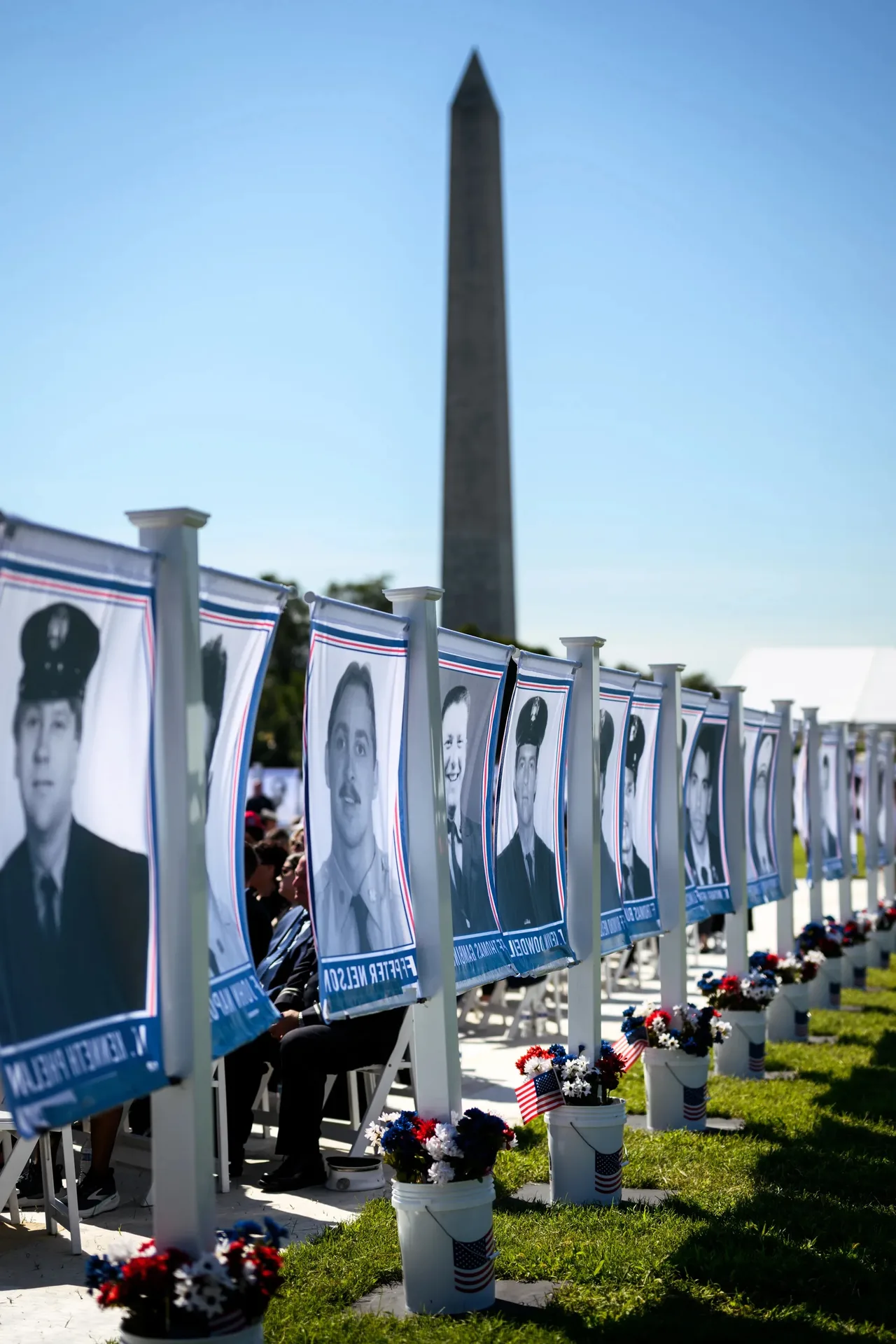 Faces of fallen first responders surround the towering steel