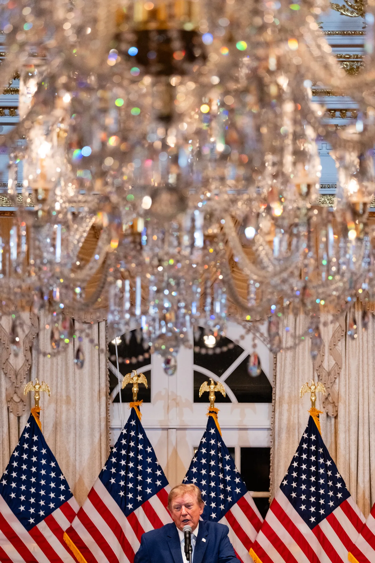Trump appears beneath a canopy of sparkling crystals