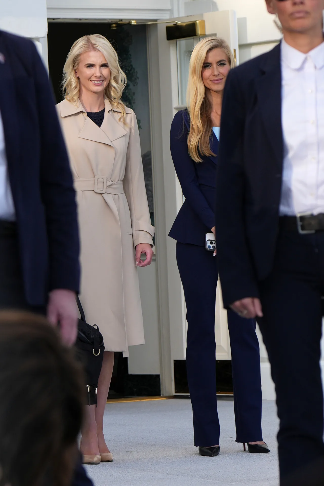 Trump's new spokesperson watches the president address reporters