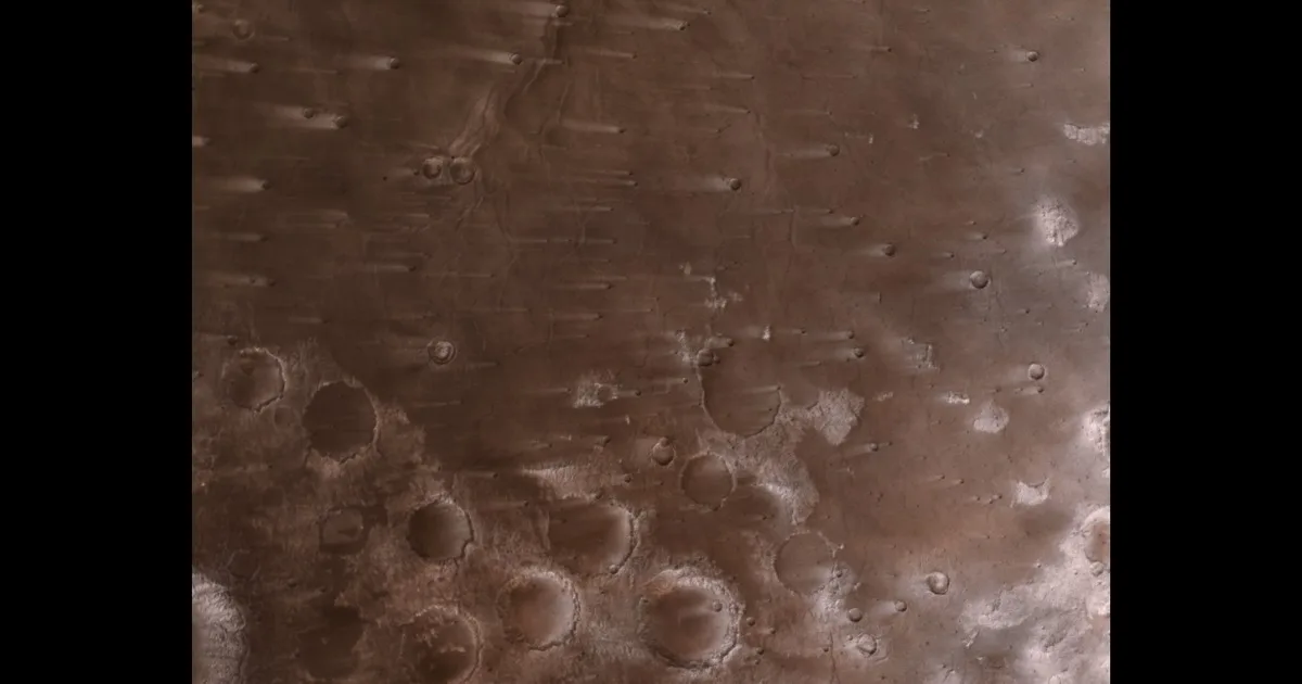 Wind-blown Martian craters observed by NASA’s Psyche mission