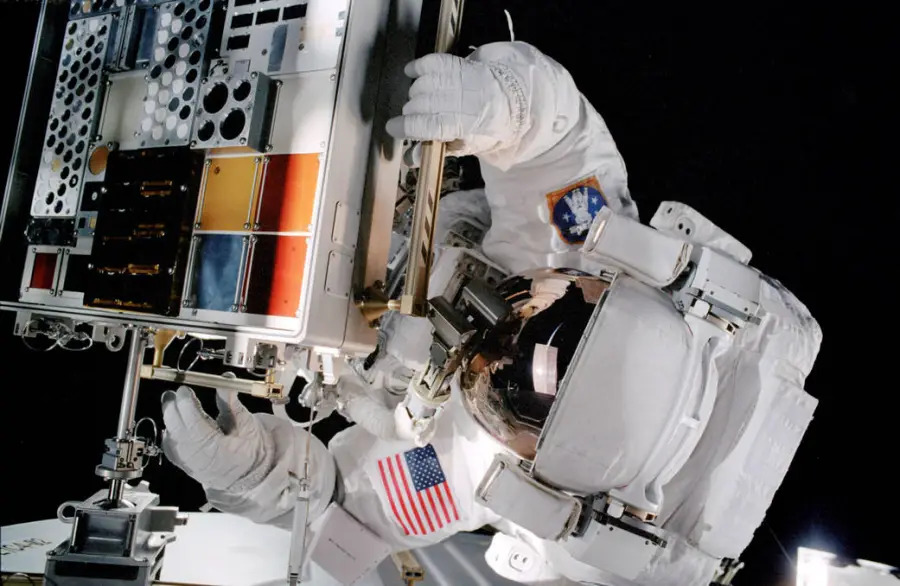 Astronaut Patrick G. Forrester works with the Materials International Space Station Experiment (MISSE) during extravehicular activity.