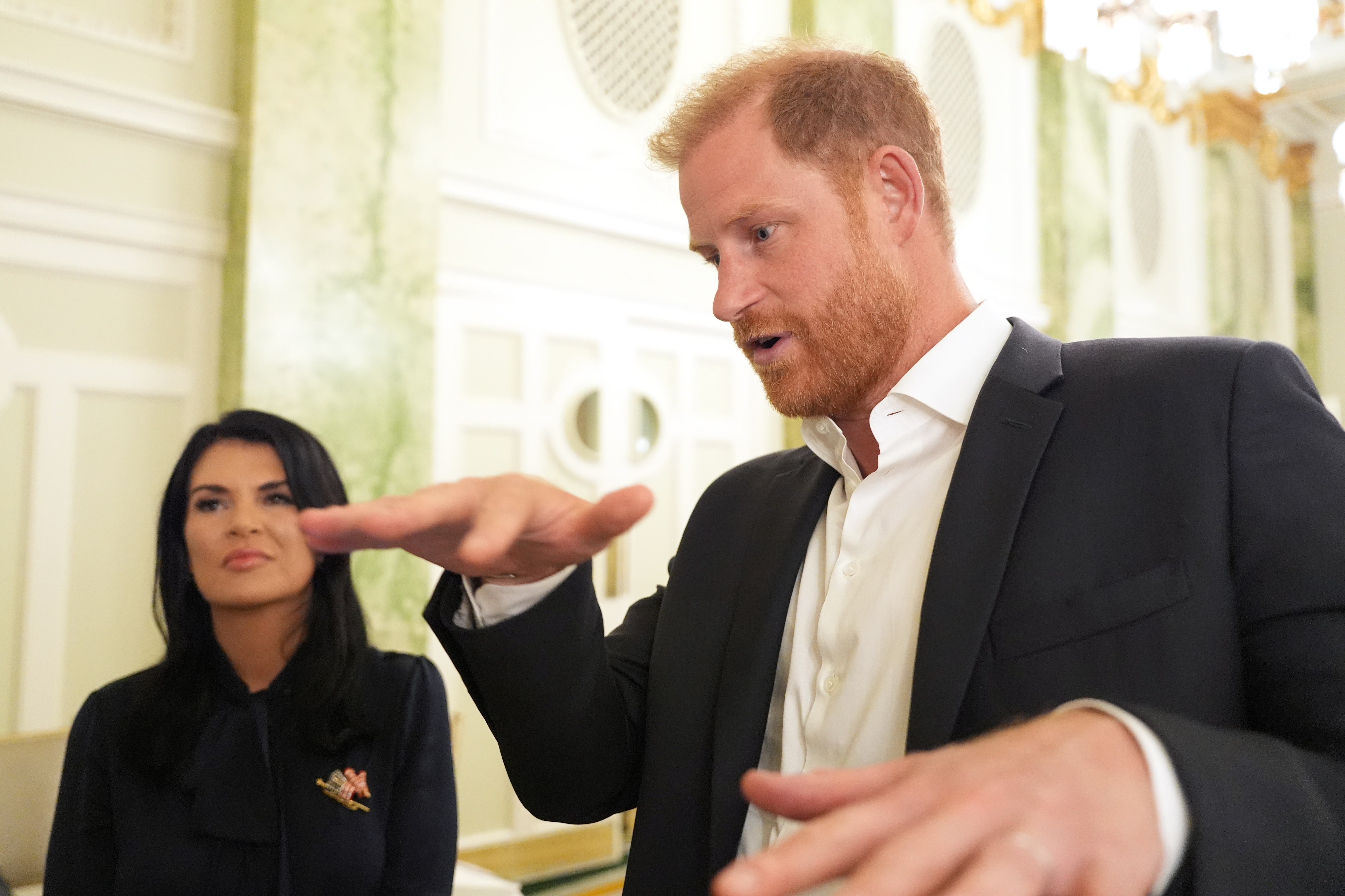 Britain's Prince Harry, the Duke of Sussex, speaks to The Associated Press after a roundtable about support for veterans, Wednesday, Aug. 19, 2026, in Washington, as Sarah Verardo, CEO, of The Independence Fund, listens. (Image Source: AP Photo | Alex Brandon)