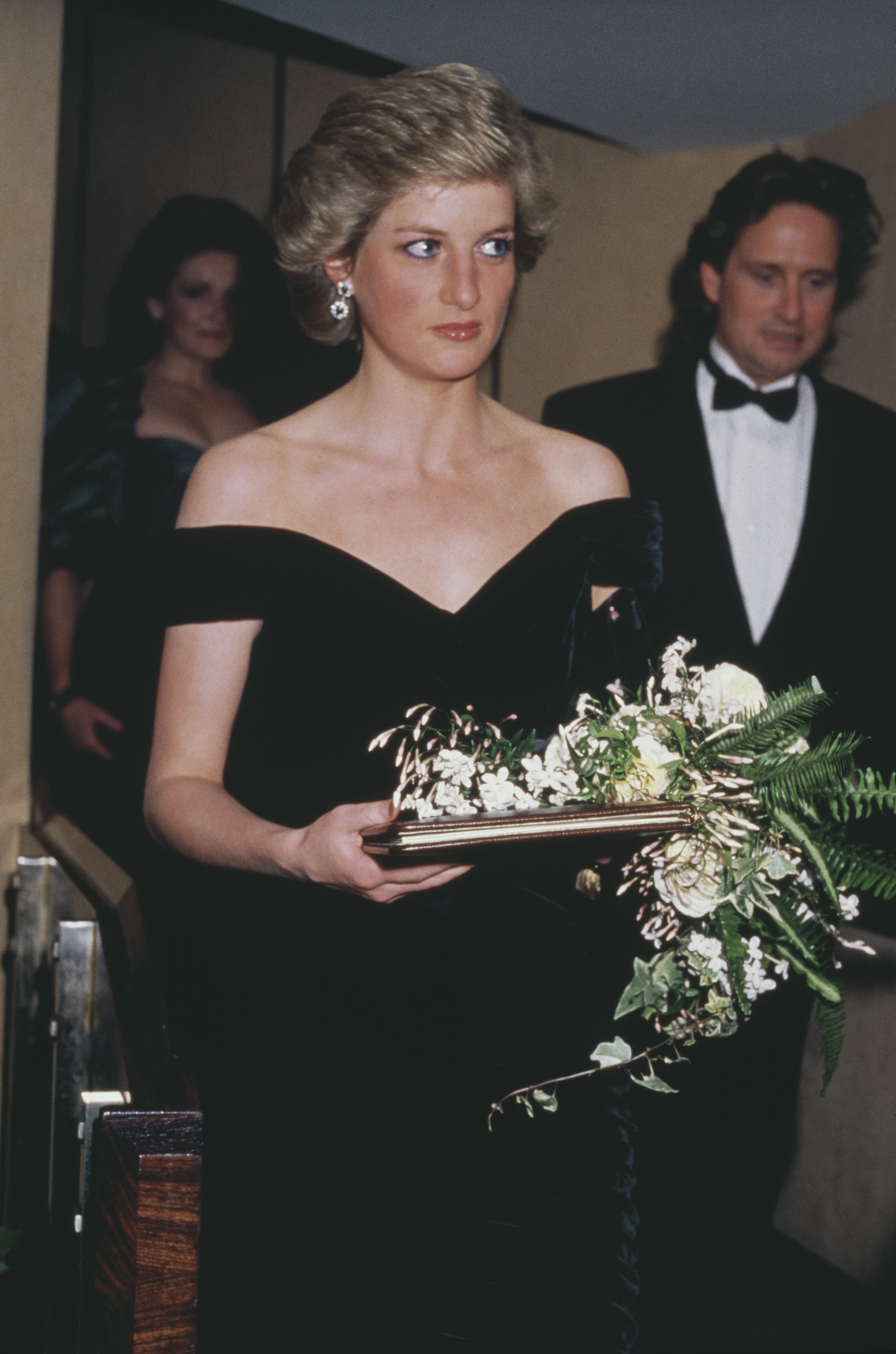 Diana, Princess of Wales, at the London premiere of the film 'Wall Street', with actor Michael Douglas in the background right. (Image Source: Getty Images | Princess Diana Archive)
