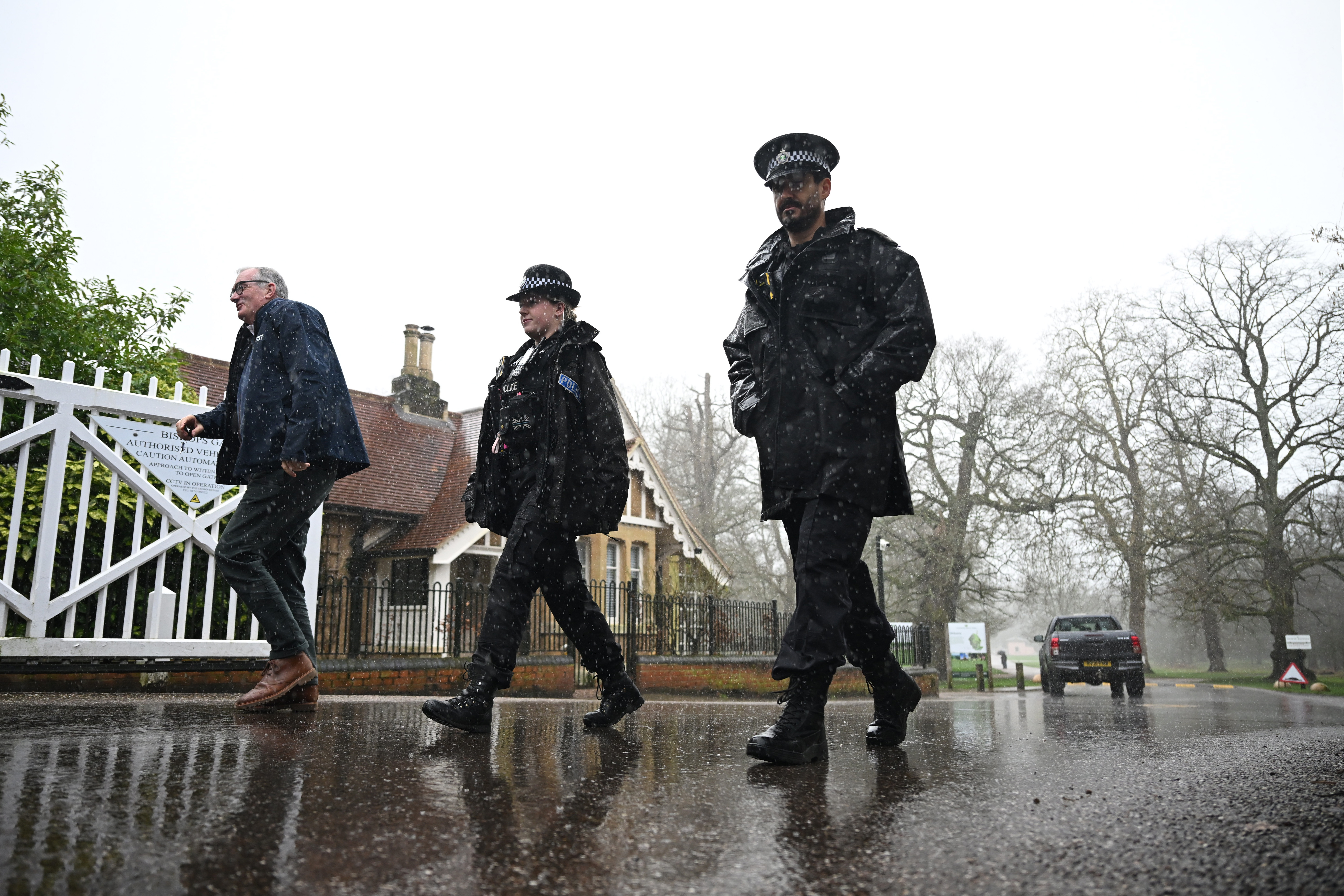 WINDSOR, ENGLAND - FEBRUARY 20: Police officers walks down the driveway from the gates of the Royal Lodge, Andrew Mountbatten-Windsor's former residence in Windsor Great Park, February 20, 2026 in Windsor, England. The former Prince Andrew was arrested yesterday at his new residence on the Sandringham estate on suspicion of misconduct in public office. In a statement, Thames Valley police said they were also