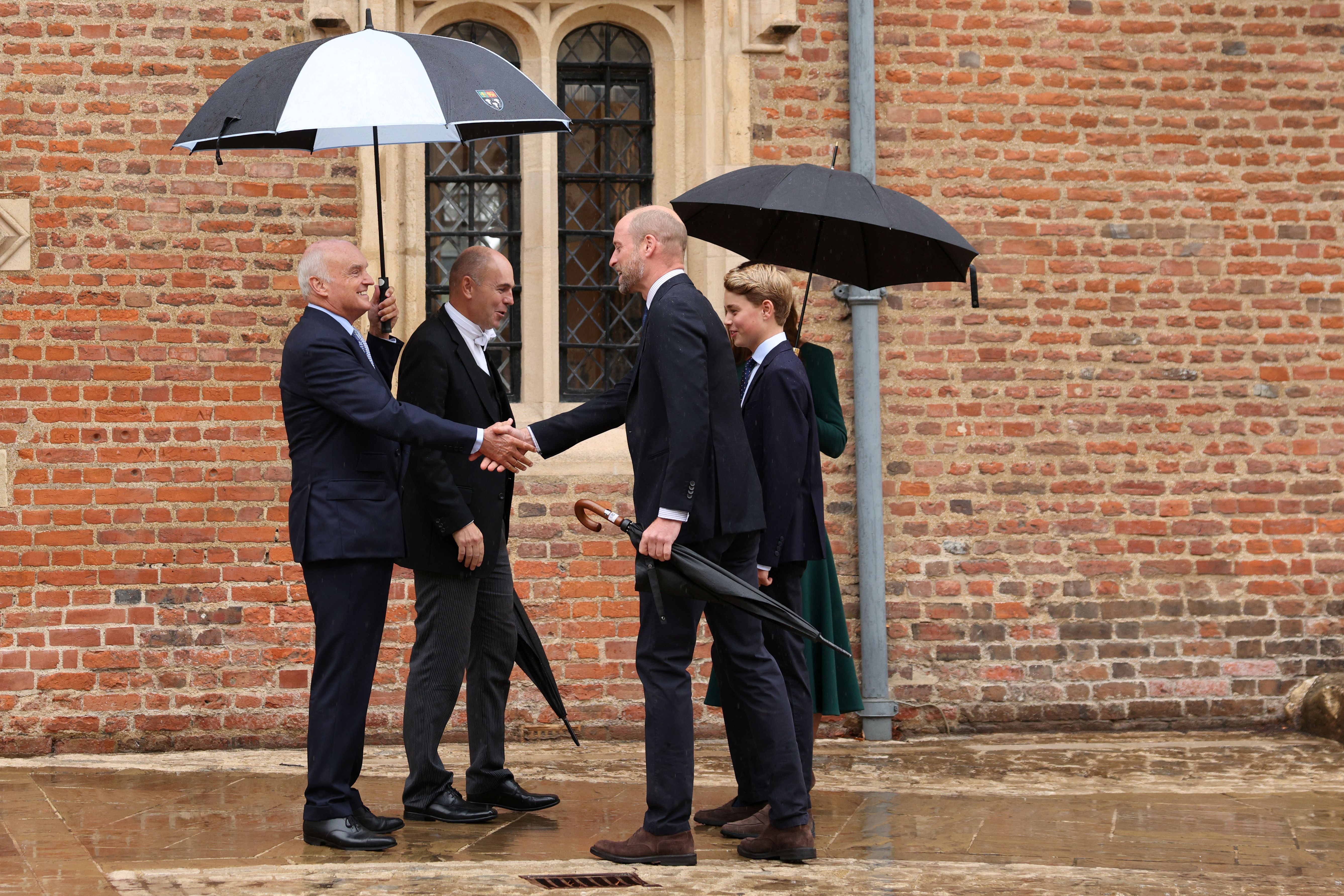 ETON, ENGLAND - SEPTEMBER 8:  Prince William, Prince of Wales (front R), Catherine, Princess of Wales (behind R) and their 13-year-old son, Prince George of Wales (R), are met by headmaster Simon Henderson (2nd L) and provost Nicholas Coleridge (L) as Prince George arrives for his first day at Eton College on September 8, 2026 in Berkshire, England. (Photo by Adrian Dennis - WPA Pool/Getty Images)