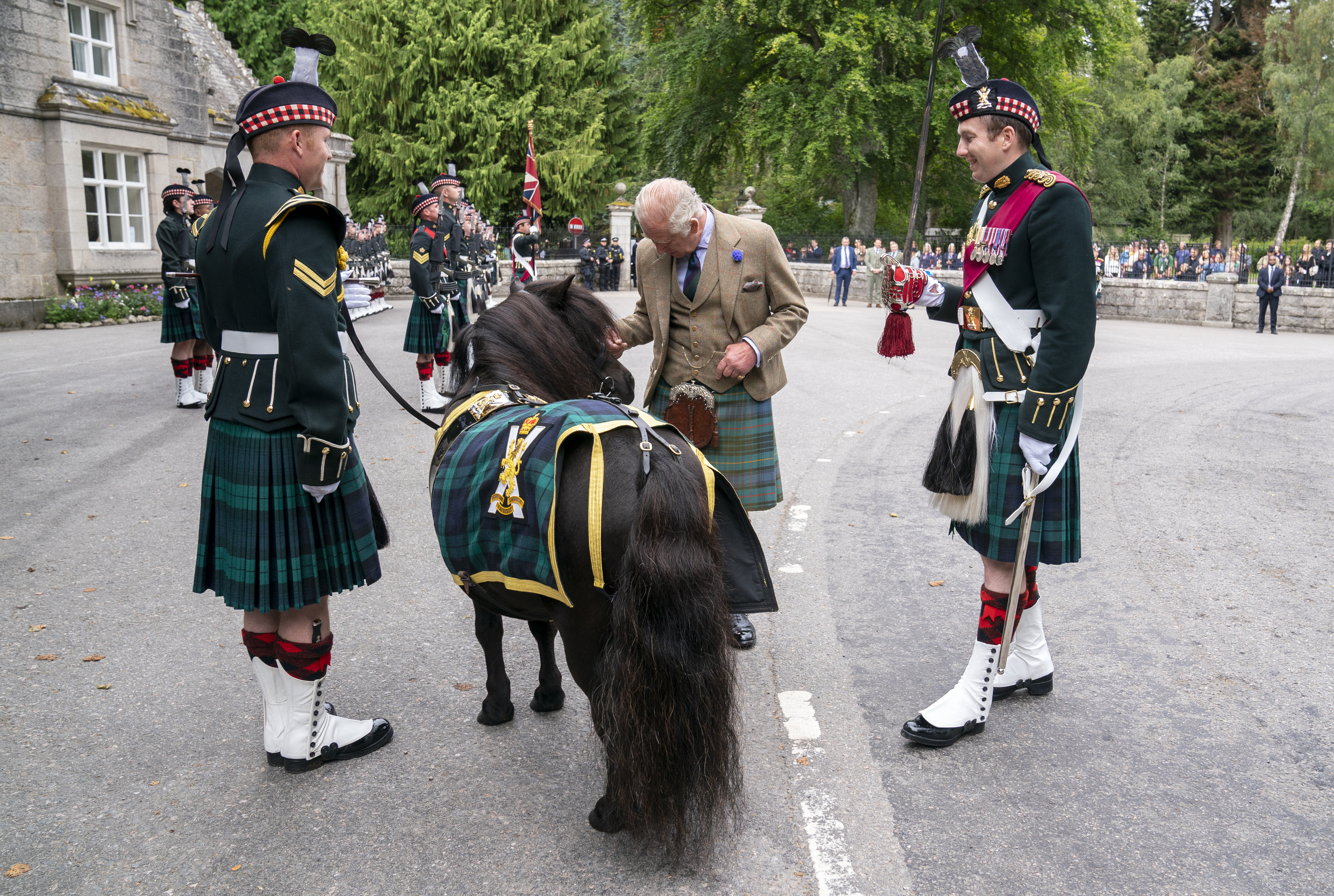 ABERDEEN, SCOTLAND - AUGUST 21: King Charles III meets the Royal Regiment of Scotland mascot Shetland pony, Corporal Cruachan IV, during the inspection of Balaklava Company, 5th Battalion, The Royal Regiment of Scotland, at the gates of Balmoral, as he takes up summer residence at Balmoral Castle on August 21, 2023 in Aberdeen, Scotland. (Photo by Jane Barlow - Pool/Getty Images)