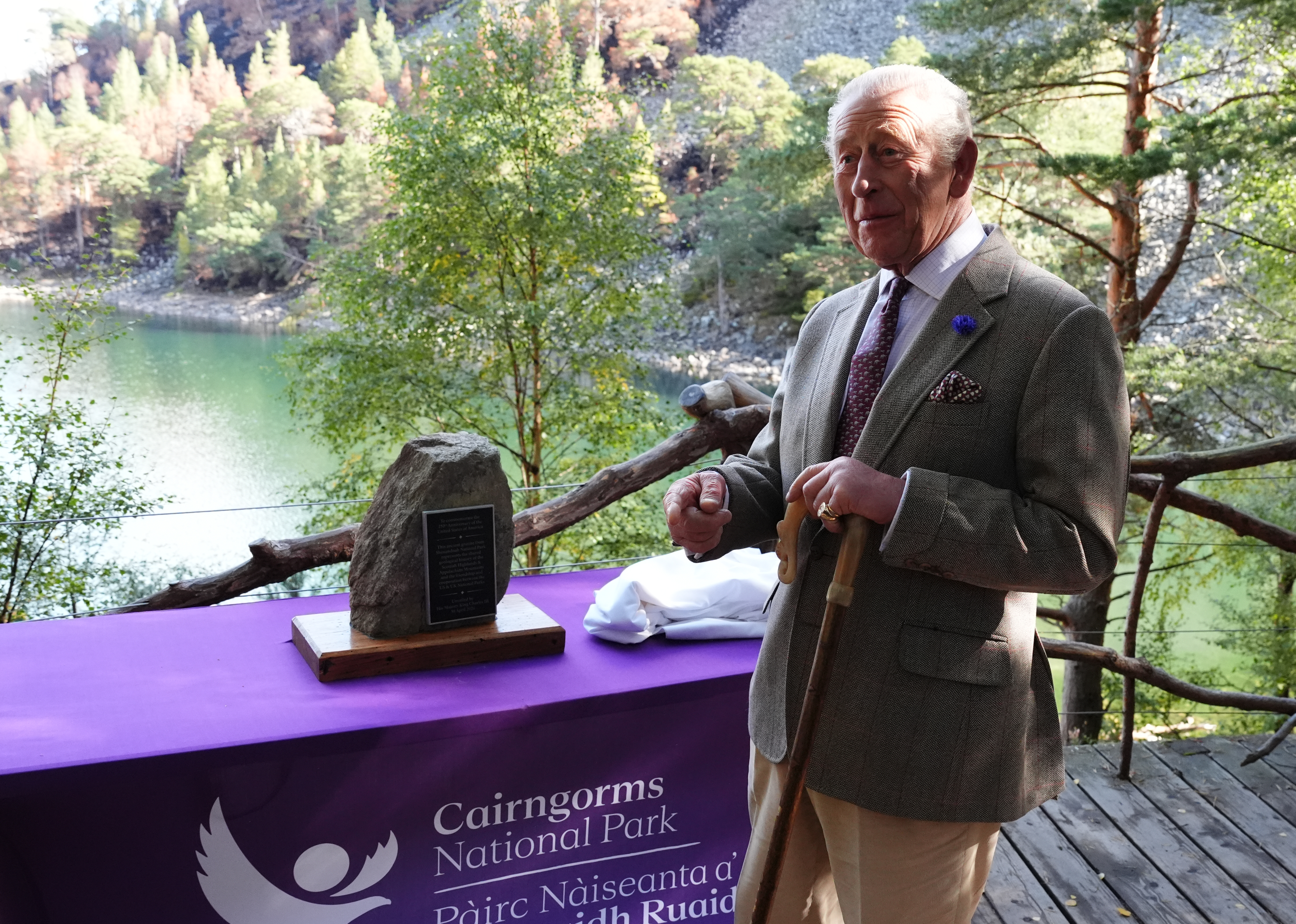 AVIEMORE, SCOTLAND - SEPTEMBER 16: King Charles III unveils the companion granite stone marking the twinning between the mountains in the Scottish Highlands and Shenandoah National Park in Virginia, celebrating the two parks' shared geological heritage when the mountains of Scotland and Appalachia formed part of the same ancient mountain range before geological forces gradually separated them across the Atlantic Ocean, during a visit to the Cairngorms National Park in the Scottish Highlands on September 16, 2026 in Aviemore, Scotland. (Photo by Andrew Milligan-Pool/Getty Images)
