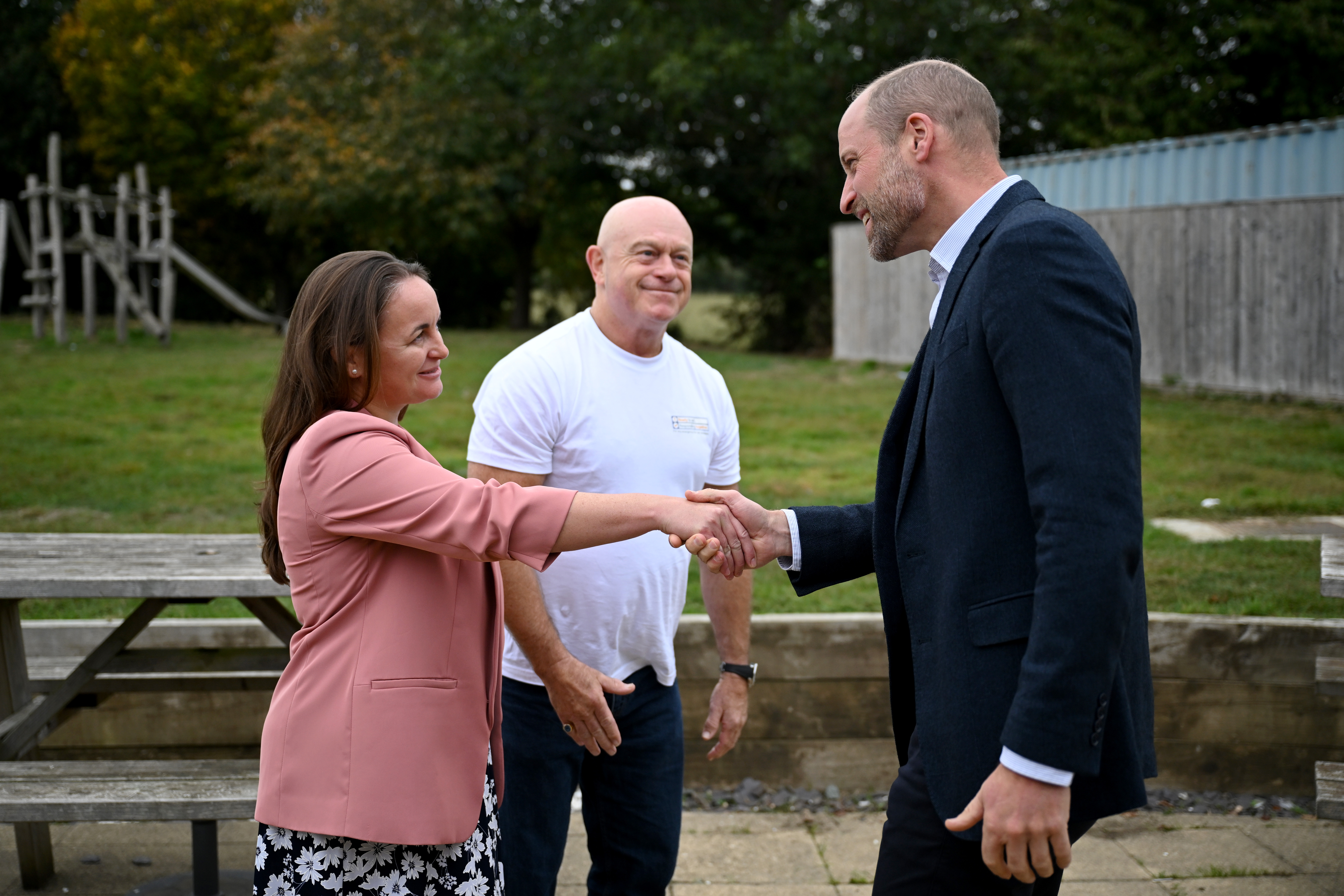 ILMINSTER, ENGLAND - OCTOBER 06: Prince William, Prince of Wales shakes hands with CEO of the National Emergencies Trust Mhairi Sharp and Ross Kemp during his visit to the launch of the National Emergency Trust's