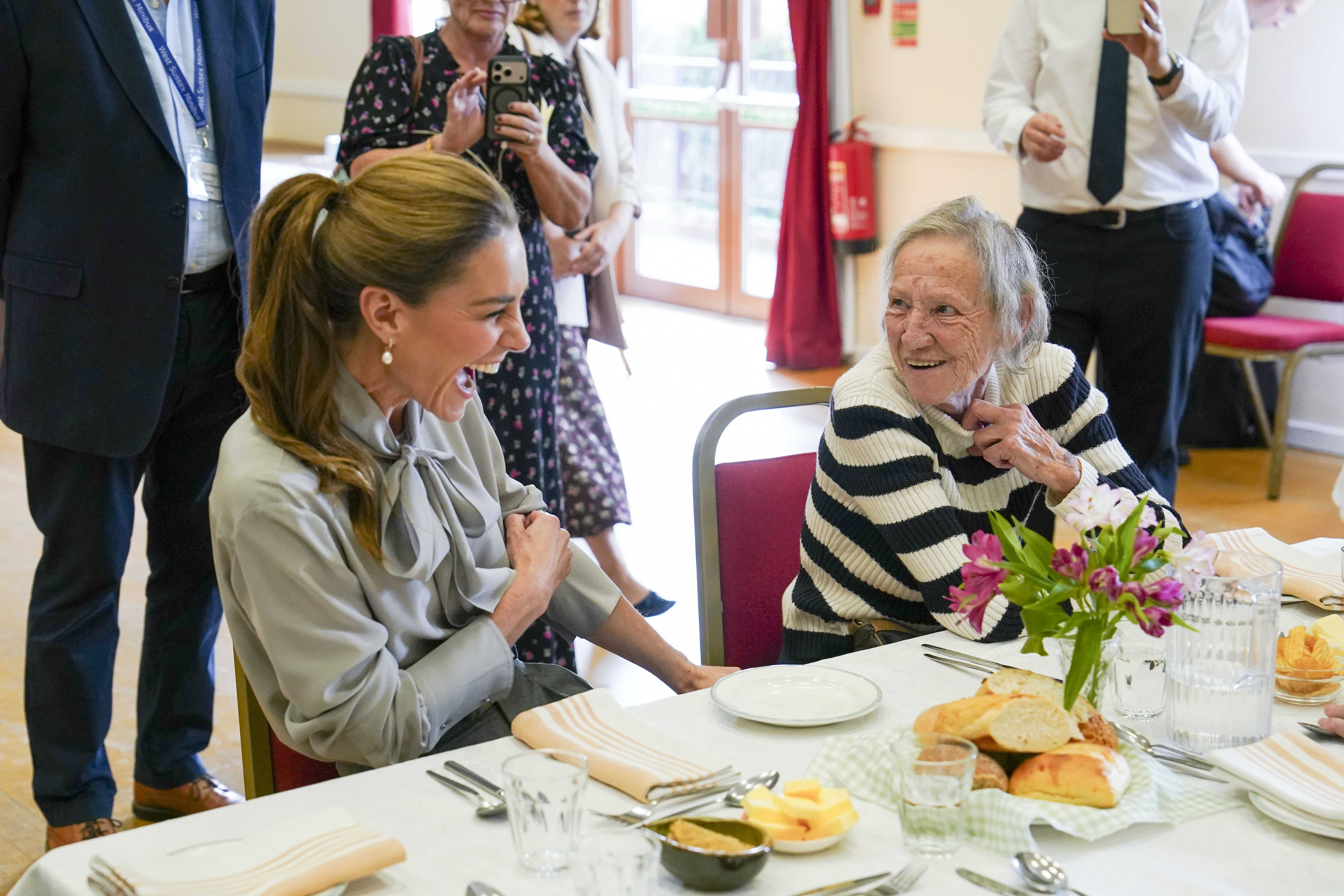 PULBOROUGH, ENGLAND - SEPTEMBER 30: Catherine, Princess of Wales talks with Lynda Jones as she visits West Sussex Minibus, a volunteer-led community transport group, which acts as a vital lifeline for people who cannot easily access public transport due to isolation, mobility challenges or financial barriers, on September 30, 2026 in Pulborough, England. The Princess's visit highlighted the role community transport plays in bringing people together. (Photo by Arthur Edwards - WPA Pool/Getty Images)