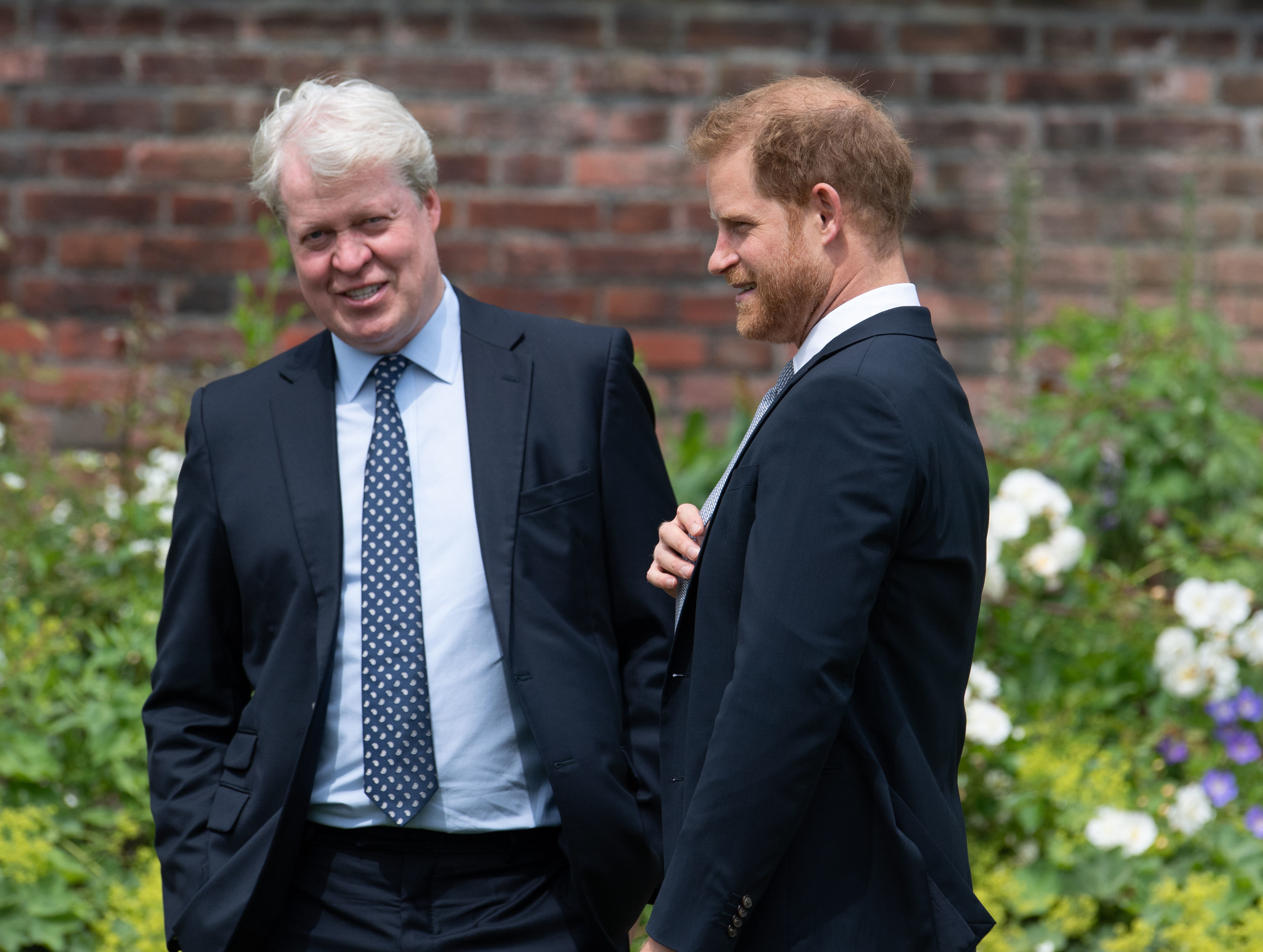 LONDON, ENGLAND - JULY 01: Prince Harry, Duke of Sussex with his uncle Earl Spencer during the unveiling of a statue of Diana, Princess of Wales, in the Sunken Garden at Kensington Palace, on what would have been her 60th birthday on July 1, 2021 in London, England. Today would have been the 60th birthday of Princess Diana, who died in 1997. At a ceremony here today, her sons Prince William and Prince Harry, the Duke of Cambridge and the Duke of Sussex respectively, will unveil a statue in her memory. (Photo by Dominic Lipinski - WPA Pool/Getty Images)