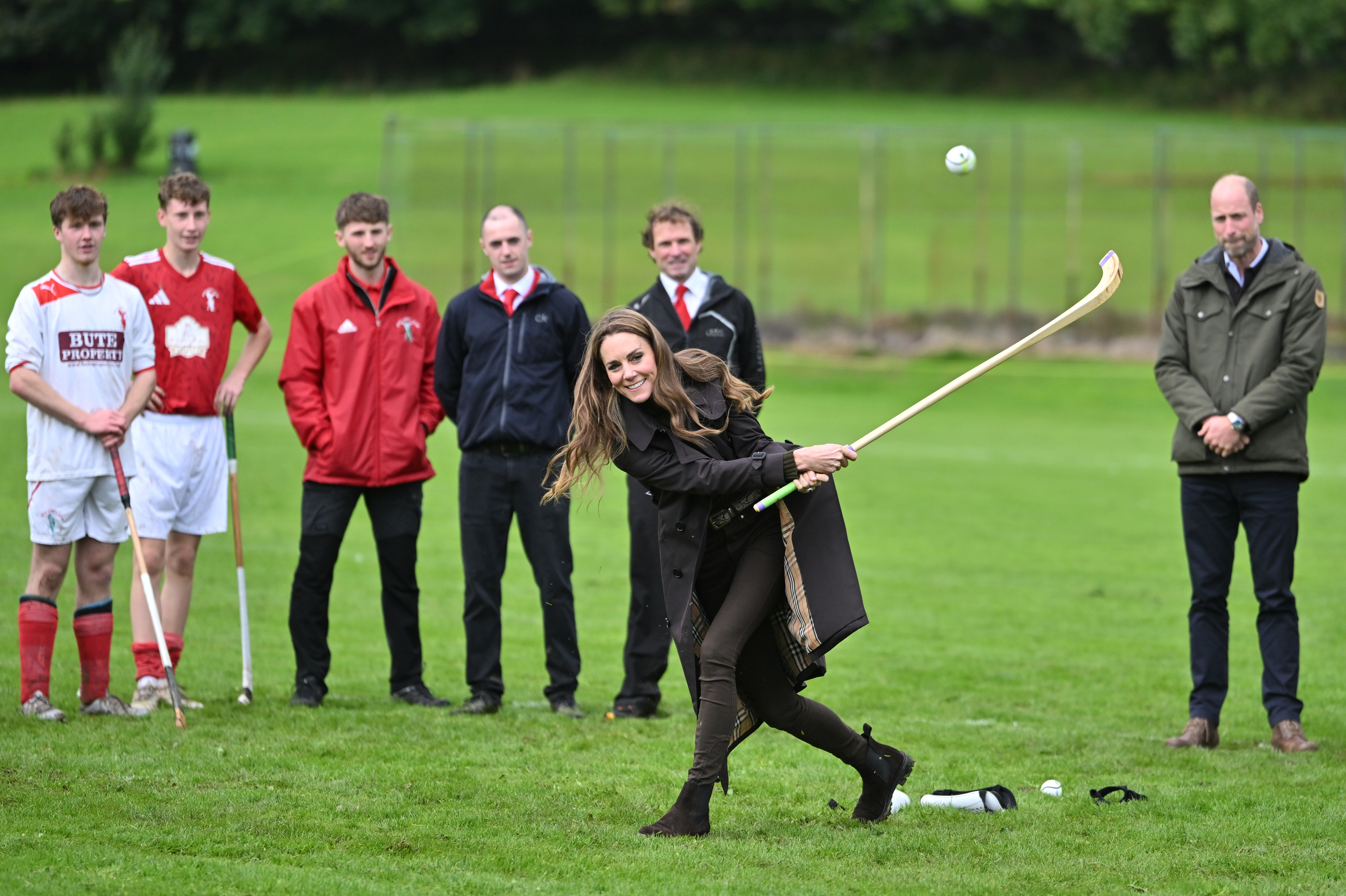 Kate Middleton plays shinty at the Bute Shinty Club in Rothesay as Prince William watches on, during a royal visit to the Isle of Bute (Image Source: Getty Images | Samir Hussein/WireImage)