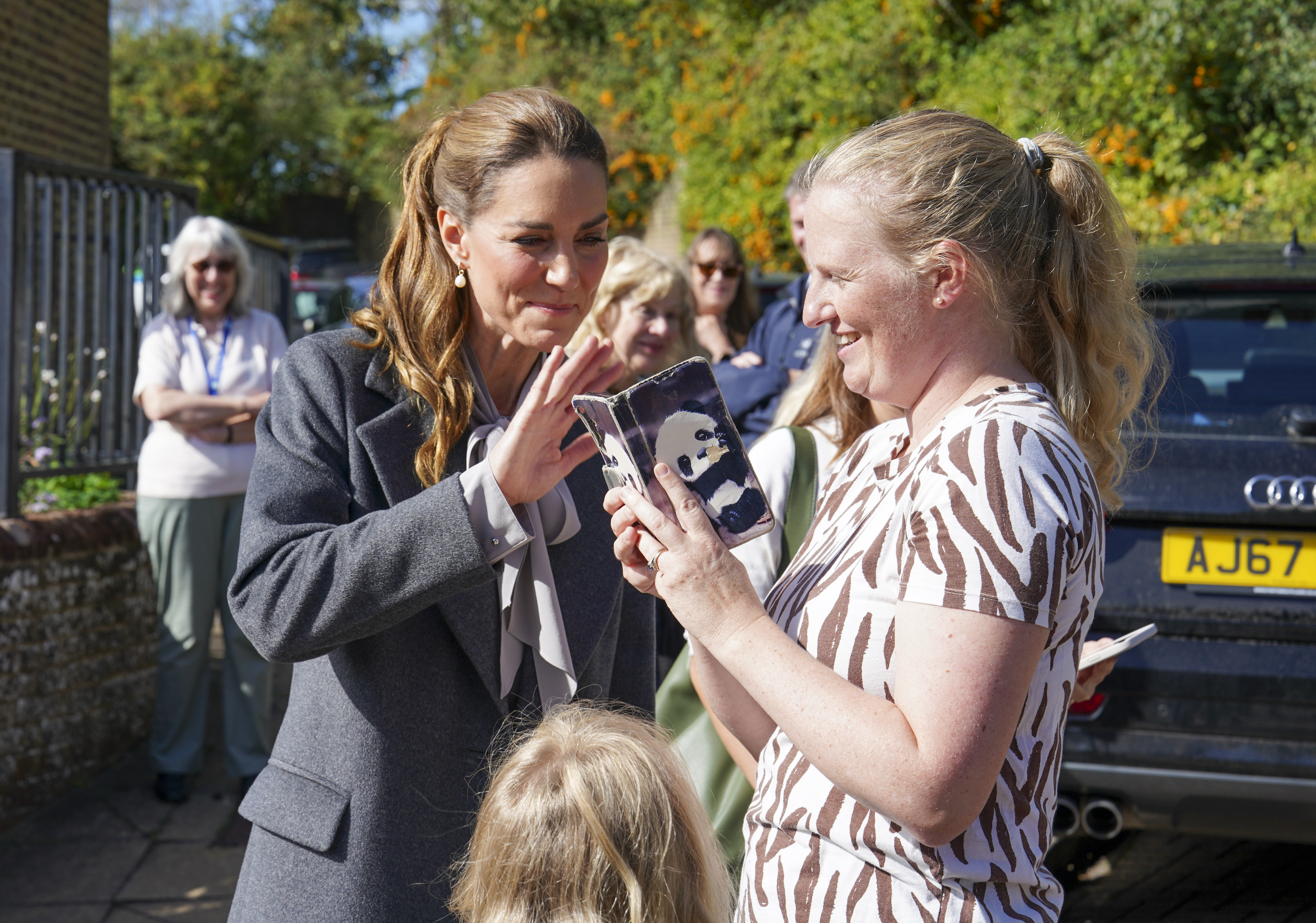 PULBOROUGH, ENGLAND - SEPTEMBER 30: Catherine, Princess of Wales waves to Amanda Ridley's mother and sister on FaceTime as she visits West Sussex Minibus, a volunteer-led community transport group, which acts as a vital lifeline for people who cannot easily access public transport due to isolation, mobility challenges or financial barriers, on September 30, 2026 in Pulborough, England. The Princess's visit highlighted the role community transport plays in bringing people together. (Photo by Arthur Edwards - WPA Pool/Getty Images)
